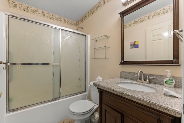 bathroom with bath / shower combo with glass door, vanity, and toilet