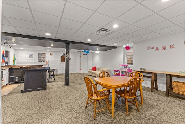 dining space featuring visible vents, light colored carpet, brick wall, a paneled ceiling, and recessed lighting