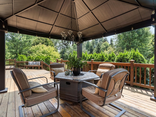 deck featuring outdoor dining area and a gazebo