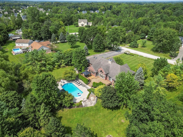 birds eye view of property featuring a wooded view