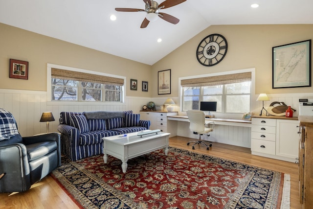 office space with lofted ceiling, a healthy amount of sunlight, wainscoting, and built in study area