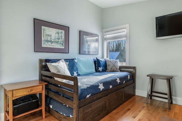 bedroom featuring baseboards and wood finished floors