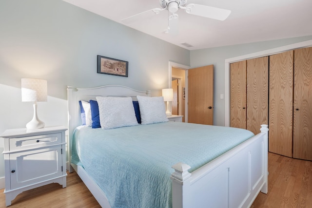 bedroom featuring ceiling fan, light wood finished floors, a closet, and visible vents