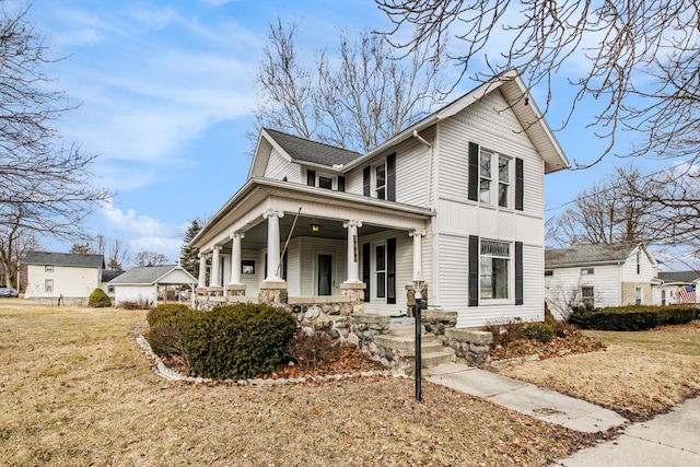 view of front facade with covered porch and a front lawn