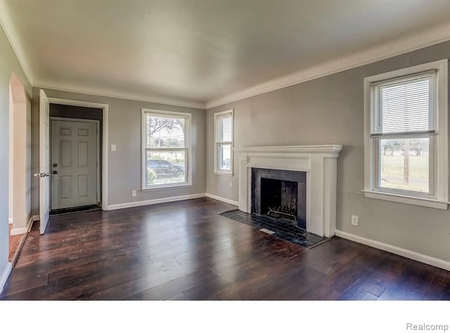 unfurnished living room with dark wood-style floors, crown molding, a fireplace with flush hearth, and baseboards