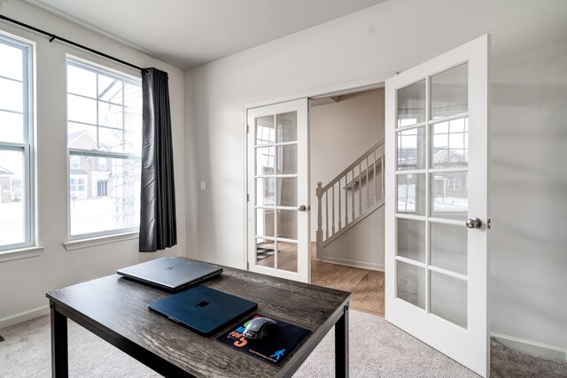 office with french doors, carpet flooring, and baseboards