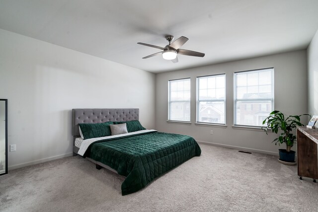 bedroom with ceiling fan, carpet floors, visible vents, and baseboards