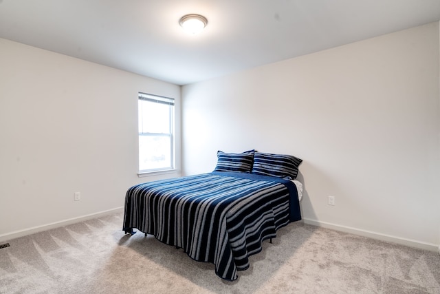 bedroom with carpet floors and baseboards