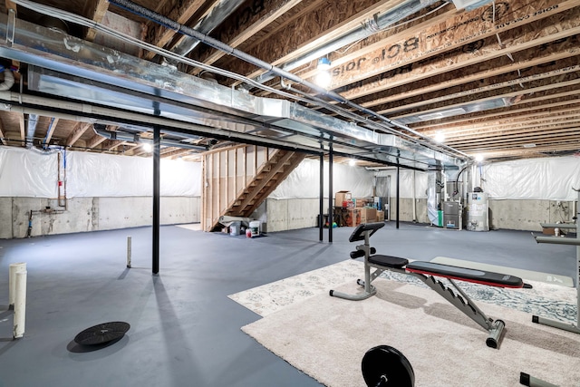 exercise area featuring heating unit and gas water heater