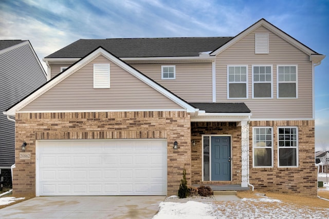 traditional home featuring a garage, driveway, roof with shingles, and brick siding