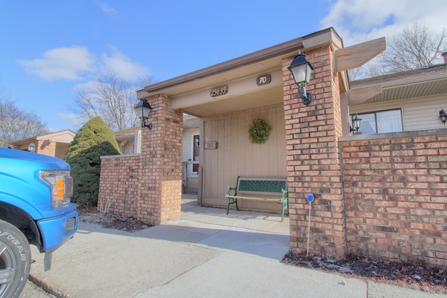 entrance to property featuring brick siding