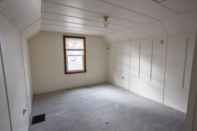 bonus room featuring lofted ceiling, visible vents, and carpet flooring