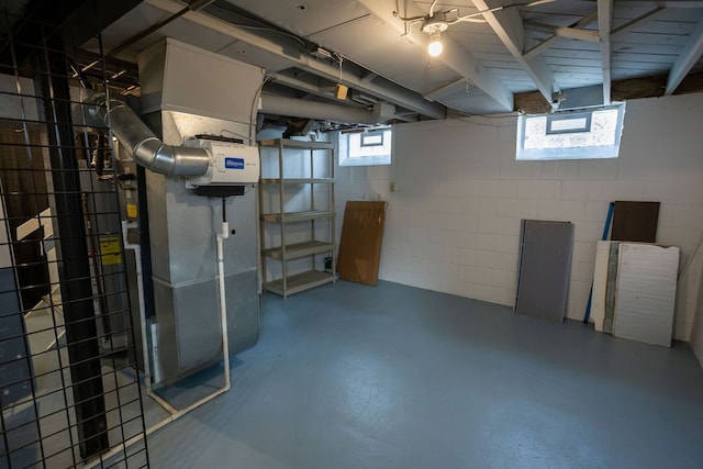 below grade area featuring concrete block wall and heating unit