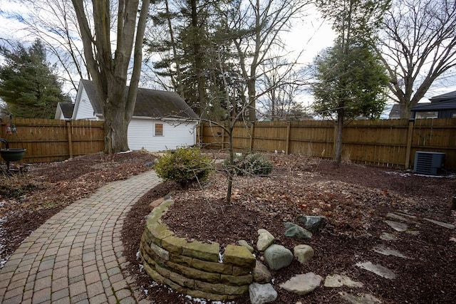 view of yard with cooling unit and a fenced backyard