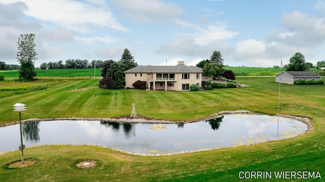 exterior space featuring a lawn and a water view