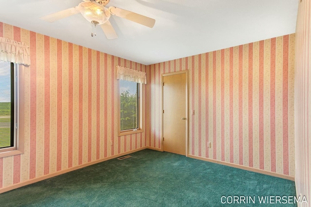 empty room with baseboards, carpet, visible vents, and wallpapered walls