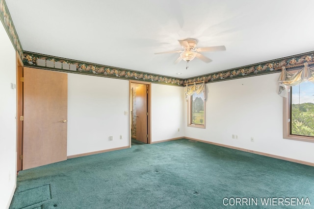 carpeted spare room with baseboards and a ceiling fan