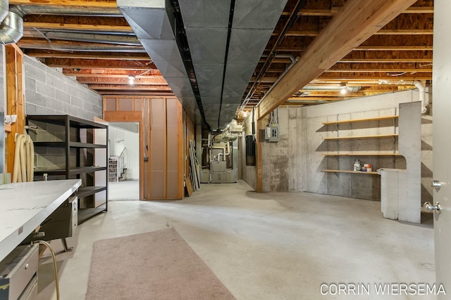 unfinished basement with electric panel and heating unit