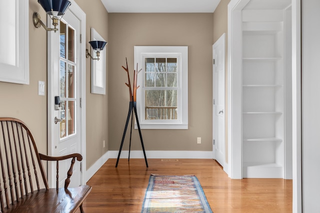 interior space featuring baseboards and wood finished floors