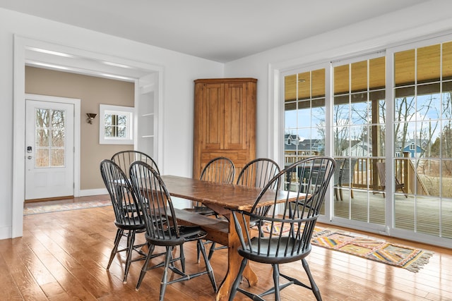 dining room with light wood finished floors and baseboards