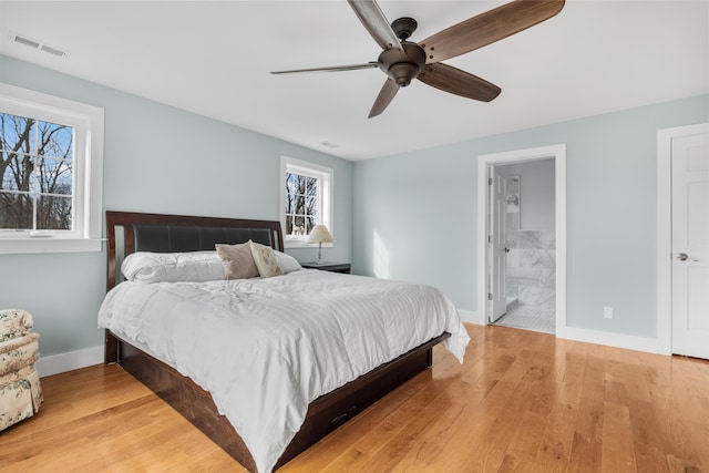 bedroom featuring light wood-type flooring, visible vents, and baseboards