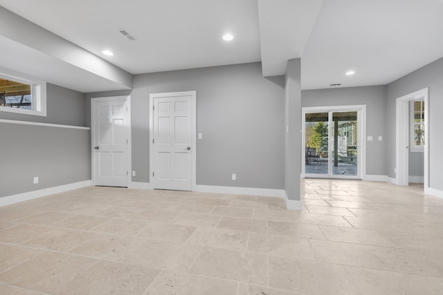 spare room with recessed lighting, visible vents, and baseboards