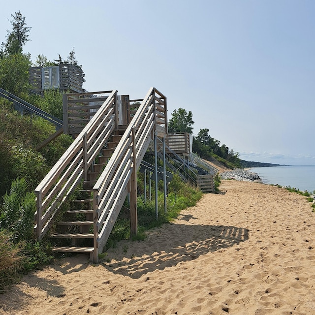 view of home's community featuring a water view and stairway