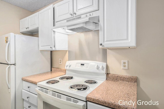 kitchen featuring white appliances, light countertops, a textured ceiling, under cabinet range hood, and white cabinetry