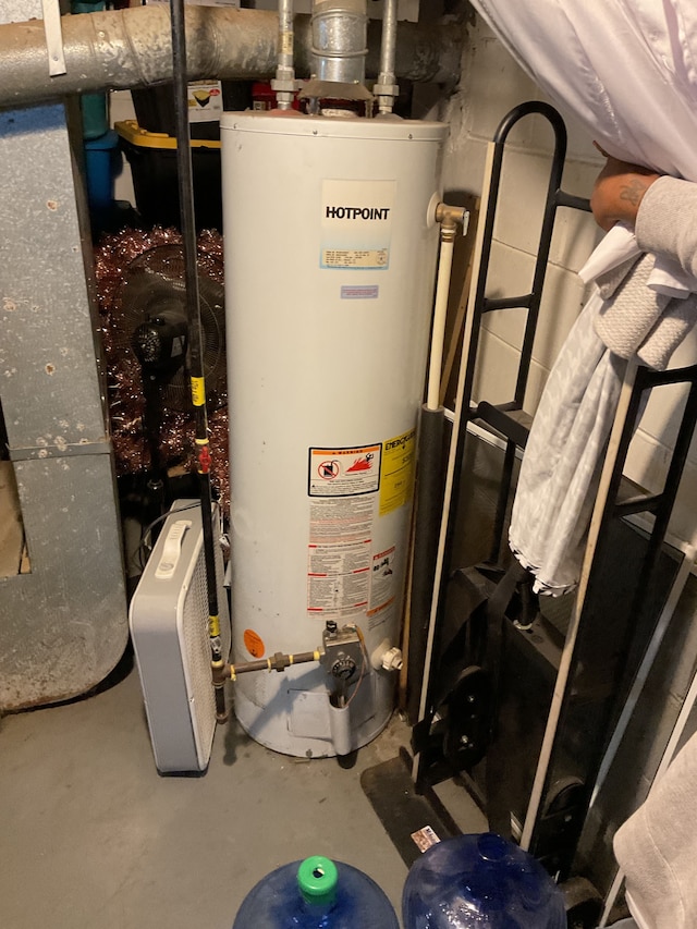 utility room featuring water heater