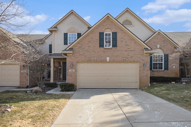 traditional-style home with a garage, brick siding, concrete driveway, and a front lawn