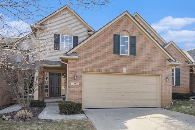 traditional-style home featuring brick siding, concrete driveway, and an attached garage