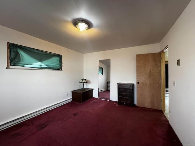 carpeted empty room with a baseboard heating unit