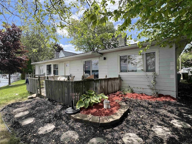 11698 Elm Park Dr, Manitou Beach, MI 49253 - rear view of property featuring a chimney and a wooden deck