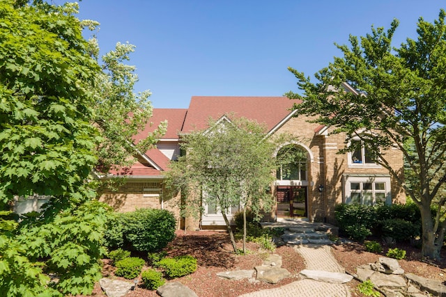 obstructed view of property featuring brick siding