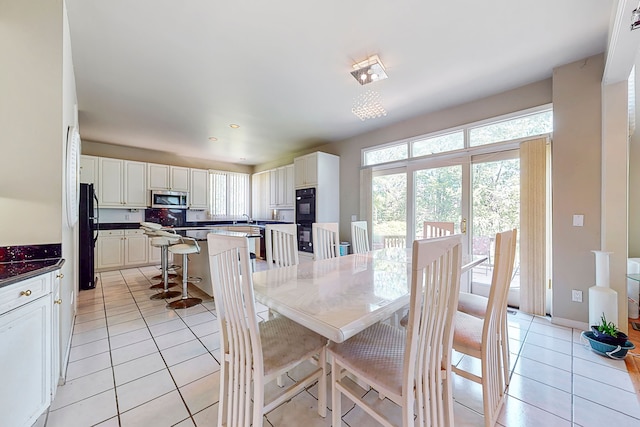 dining area with light tile patterned flooring and baseboards