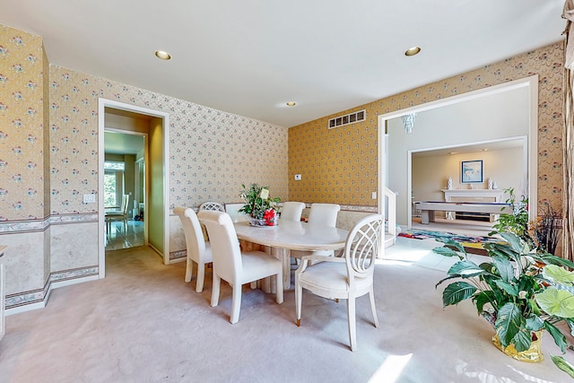 dining space featuring carpet floors, recessed lighting, visible vents, and wallpapered walls