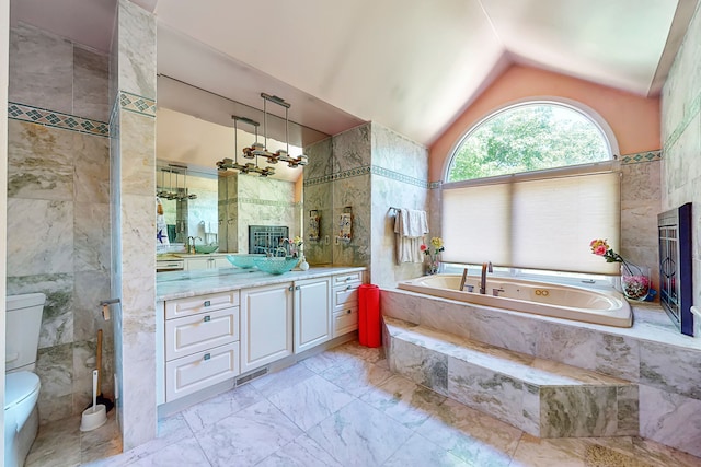 full bath featuring vaulted ceiling, vanity, and tile walls