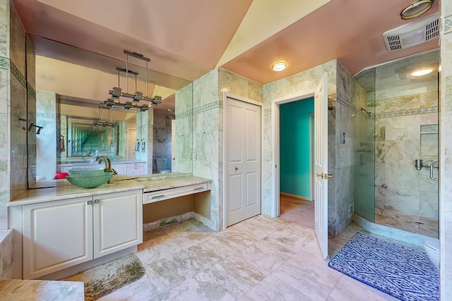 full bath with visible vents, marble finish floor, vaulted ceiling, vanity, and a shower stall