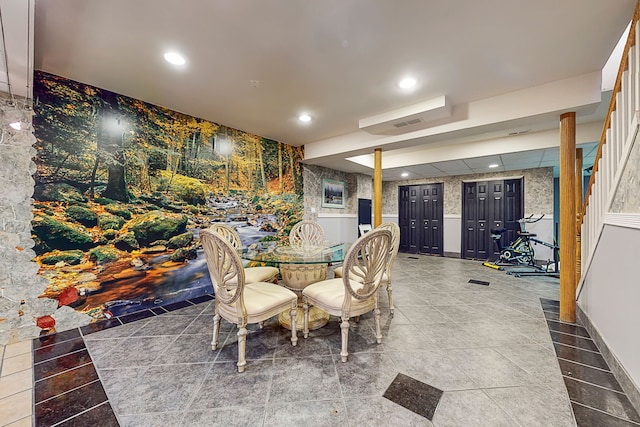 tiled dining area featuring a wainscoted wall, recessed lighting, and wallpapered walls