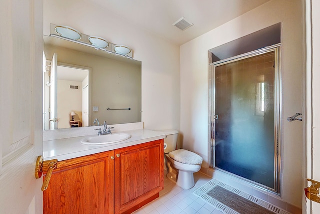 bathroom with tile patterned flooring, toilet, vanity, visible vents, and a stall shower