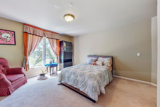 bedroom with carpet flooring and baseboards