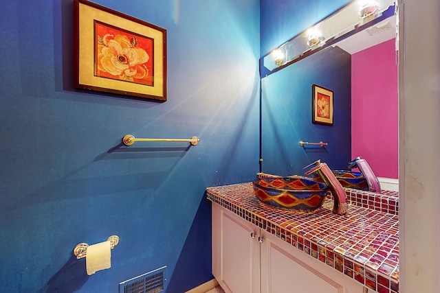 bathroom with vanity and visible vents