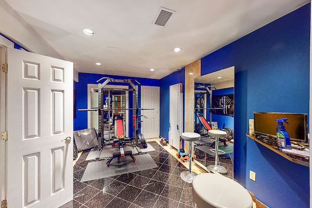 workout room featuring granite finish floor, visible vents, and recessed lighting