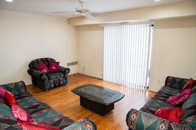 living room featuring a ceiling fan, recessed lighting, visible vents, and wood finished floors