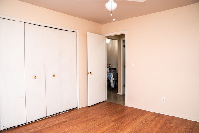 unfurnished bedroom featuring a closet and wood finished floors