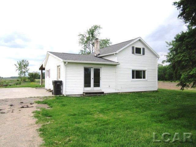 back of house featuring a chimney, french doors, and a yard