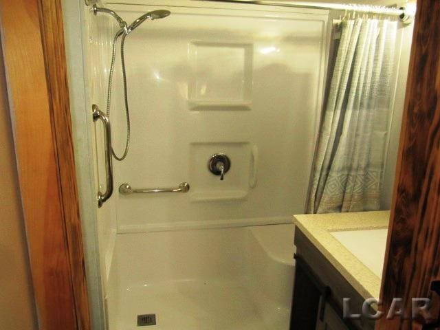 bathroom with a shower with curtain and vanity