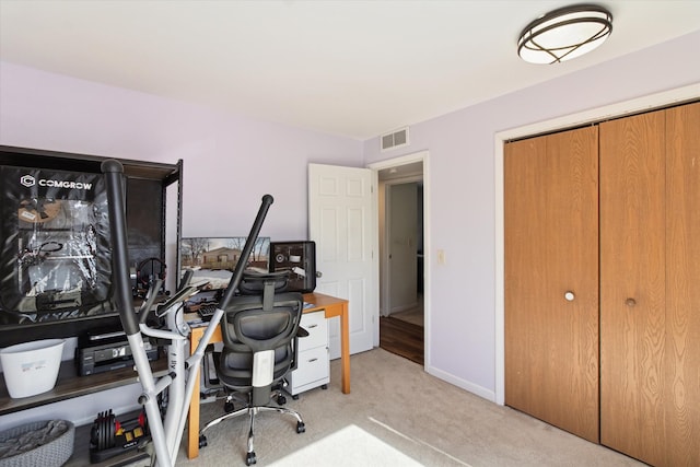 carpeted office with visible vents and baseboards