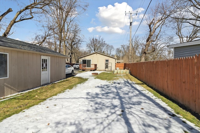 view of side of property featuring fence and an outbuilding