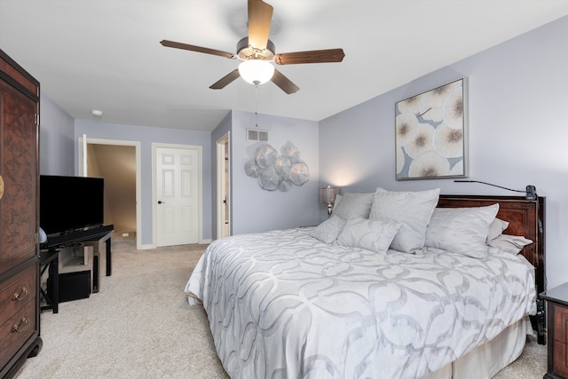 bedroom featuring a ceiling fan, visible vents, and light colored carpet